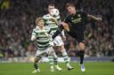 Toni Kroos and Kyogo Furuhashi fight for possession during a UEFA Champions League game at Celtic Park