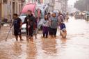 People walk through flooded streets in Valencia