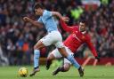 Rodri and Casemiro battle for the ball