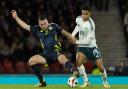 Shea Charles and John McGinn fight for possession