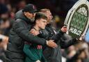 Liverpool manager Jurgen Klopp embraces substitute Ben Doak on the touchline during a Premier League match at Villa Park