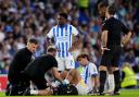 Matt O'Riley receives treatment following the tackle