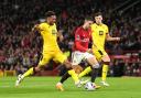 Sheffield United's Auston Trusty challenges Manchester United's Diogo Dalot during a Premier League match at Old Trafford