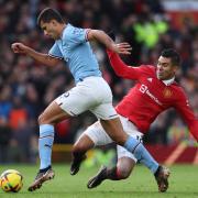 Rodri and Casemiro battle for the ball