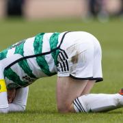 Celtic's Callum McGregor goes down injured during a cinch Premiership match against Dundee