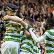 Mikael Lustig celebrates while wearing a police hat