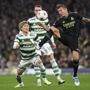 Toni Kroos and Kyogo Furuhashi fight for possession during a UEFA Champions League game at Celtic Park