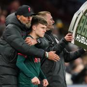 Liverpool manager Jurgen Klopp embraces substitute Ben Doak on the touchline during a Premier League match at Villa Park