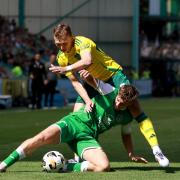 Hibernian's Rudi Molotnikov (left) and Celtic's Alistair Johnston battle for the ball during the William Hill Premiership match at Easter Road Stadium, Edinburgh. Picture date: Sunday August 11, 2024. PA Photo. See PA story SOCCER Hibernian. Photo credit