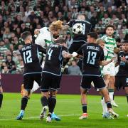 Celtic’s Liam Scales scored despite being challenged by several Slovan Bratislava players