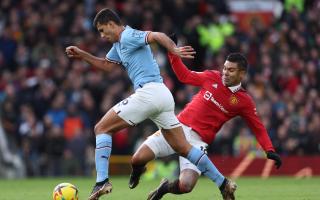 Rodri and Casemiro battle for the ball