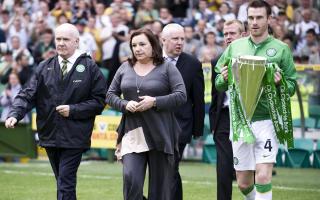 Celtic captain Stephen McManus (right) parades the SPL trophy while chairman John Reid leads Rosemary Burns, widow of club legend Tommy Burns onto the pitch to unfurl the championship flag. in 2008