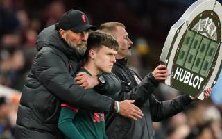 Liverpool manager Jurgen Klopp embraces substitute Ben Doak on the touchline during a Premier League match at Villa Park