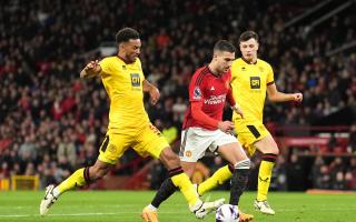 Sheffield United's Auston Trusty challenges Manchester United's Diogo Dalot during a Premier League match at Old Trafford