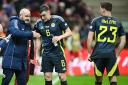 Scotland manager Steve Clarke, left, gives out instructions to John Souttar, centre, as Kenny McLean, right, looks on in Warsaw on Monday night