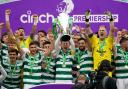 Celtic captain Callum McGregor holds aloft the Scottish Premiership trophy