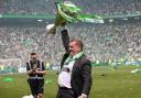 Celtic boss Ange Postecoglou celebrates with the Scottish Premiership trophy