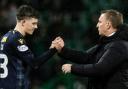 Owen Beck shakes hands with Celtic boss Brendan Rodgers