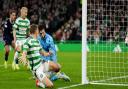 Alistair Johnston looks on at his goal against Dundee at Celtic Park