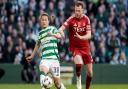 Daizen Maeda and Nicky Devlin fight for possession at Celtic Park