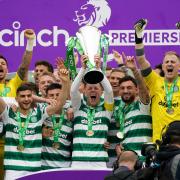 Celtic captain Callum McGregor holds aloft the Scottish Premiership trophy