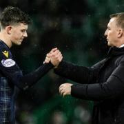 Owen Beck shakes hands with Celtic boss Brendan Rodgers