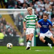 Celtic's Luke McCowan (left) and Rangers' Nicolas Raskin battle for the ball