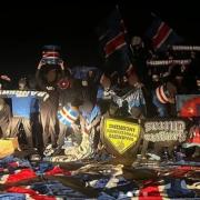 The Green Brigade pose with in the Union Bears' clothes and hold their banners aloft